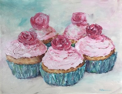 5 pink cupcakes with pink roses on blue wrappers