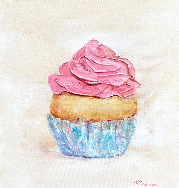 colourful pink icing cupcake with a blue wrapper