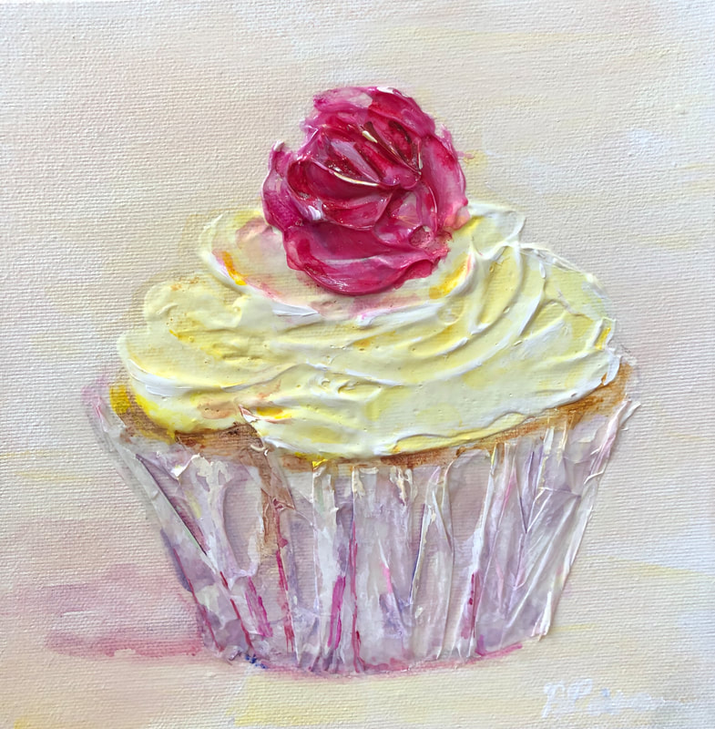 yellow cupcake with pink rose and purple wrapper